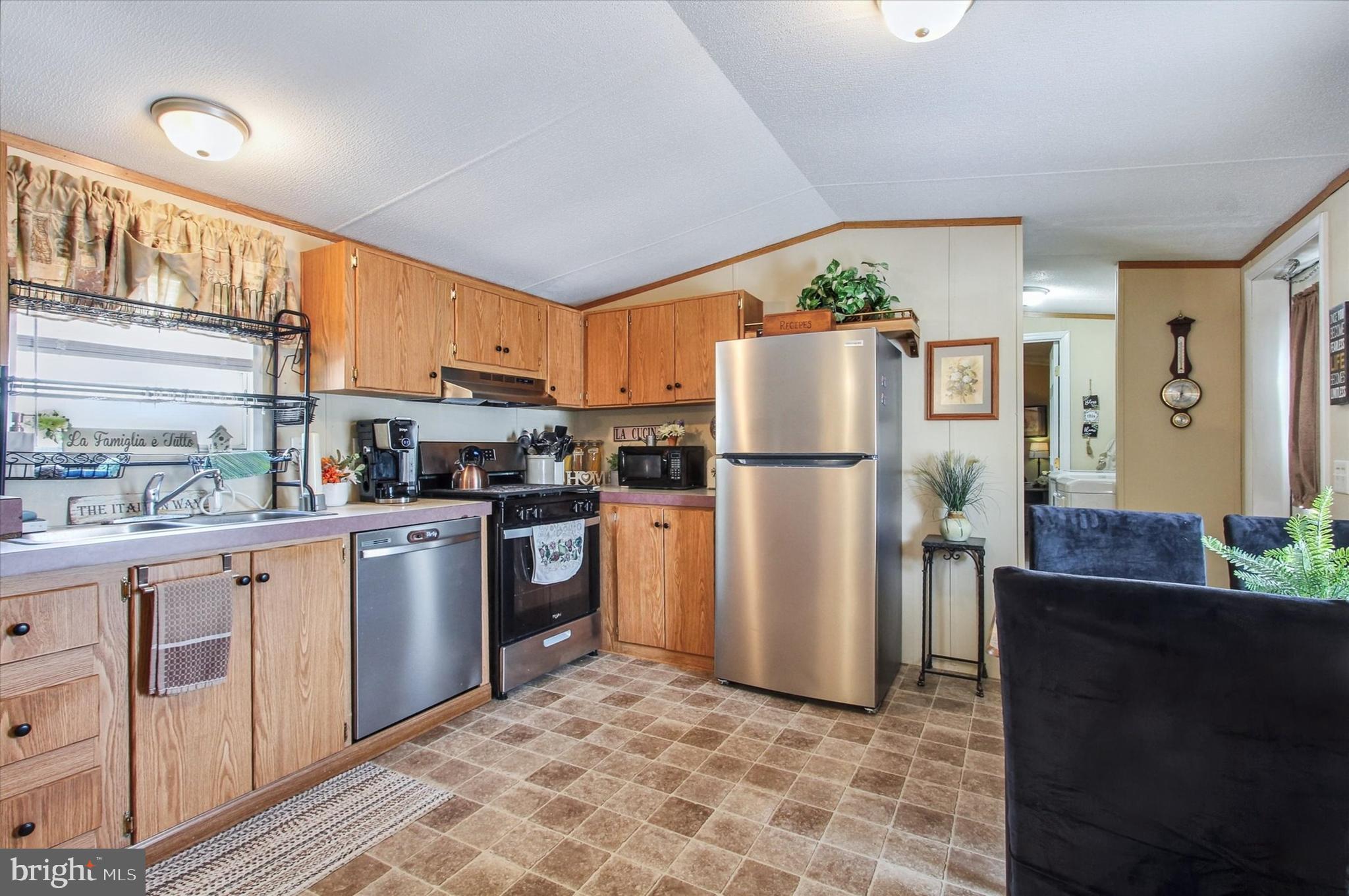 2215 Biglerville Road, Unit 15 Gettysburg, PA 17325 - Photo 10 of 21 a kitchen with stainless steel appliances granite countertop a refrigerator a stove a sink a microwave and island