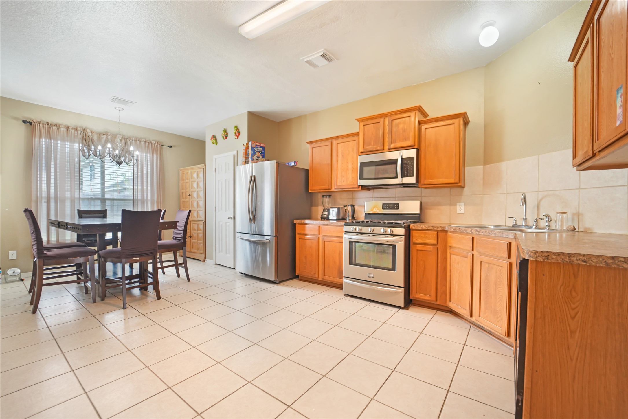 15835 Flagstone Walk Way Houston, TX 77049 - Photo 3 of 8 a kitchen with granite countertop cabinets and stainless steel appliances