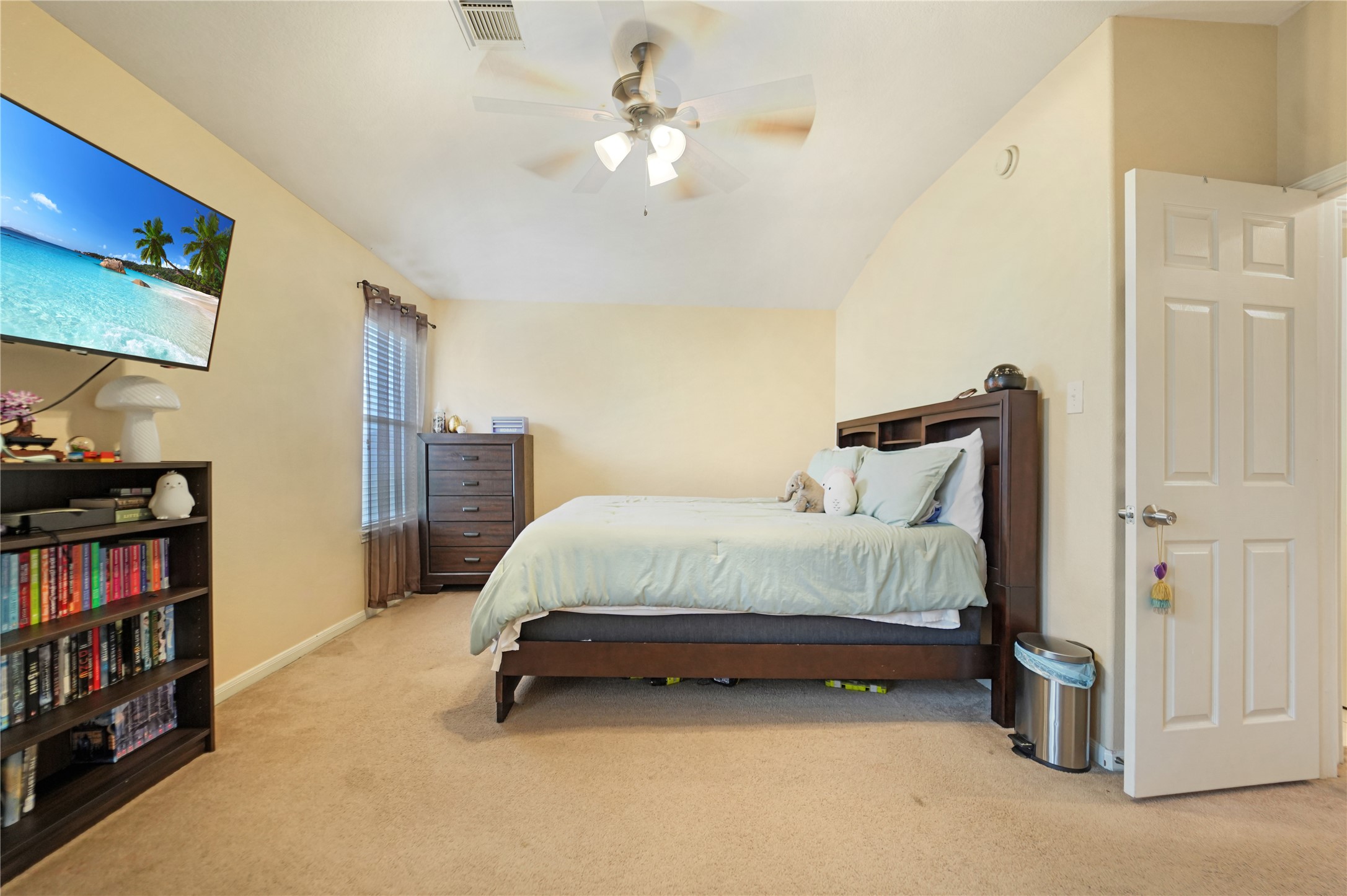 15835 Flagstone Walk Way Houston, TX 77049 - Photo 5 of 8 a bedroom with a bed and a book shelf
