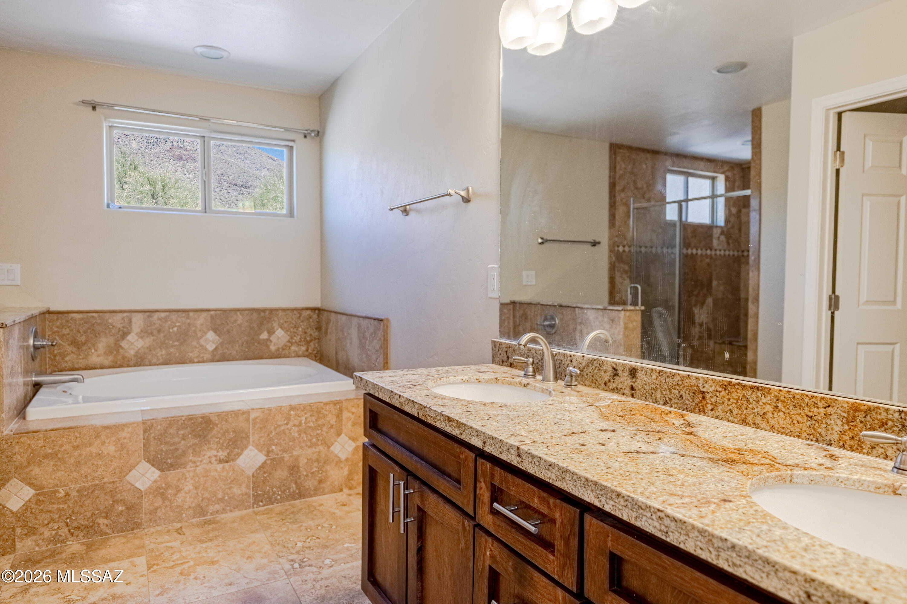 545 East Rancho Catalina Place Tucson, AZ 85704 - Photo 12 of 13 a bathroom with a granite countertop bathtub sink and mirror
