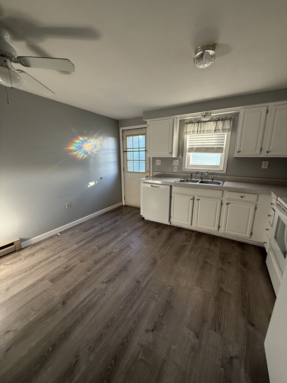 a kitchen with granite countertop cabinets and wooden floor