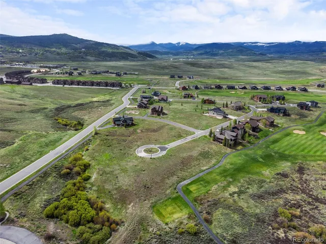a view of a lush green hillside and houses