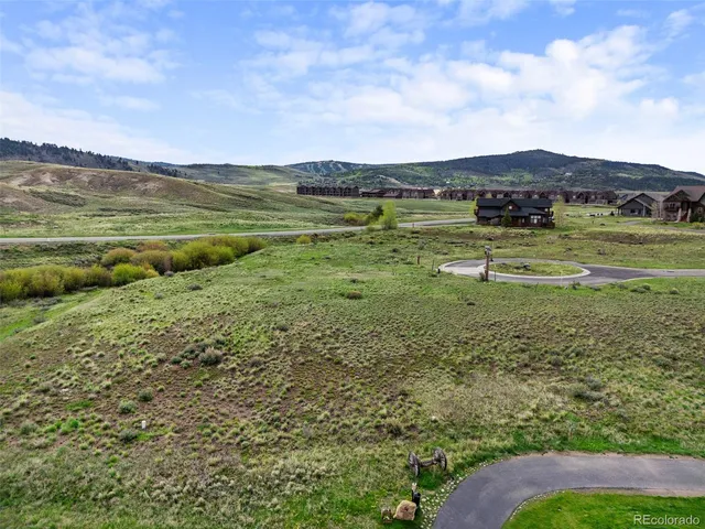 a view of a field with an ocean