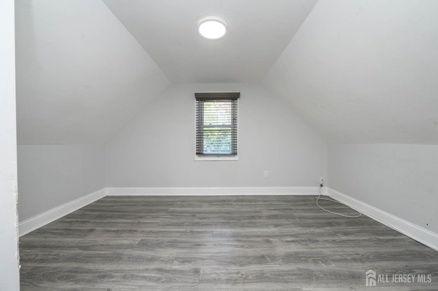 32 Lee Street Port Reading, NJ 07064 - Photo 25 of 32 wooden floor in an empty room with a window