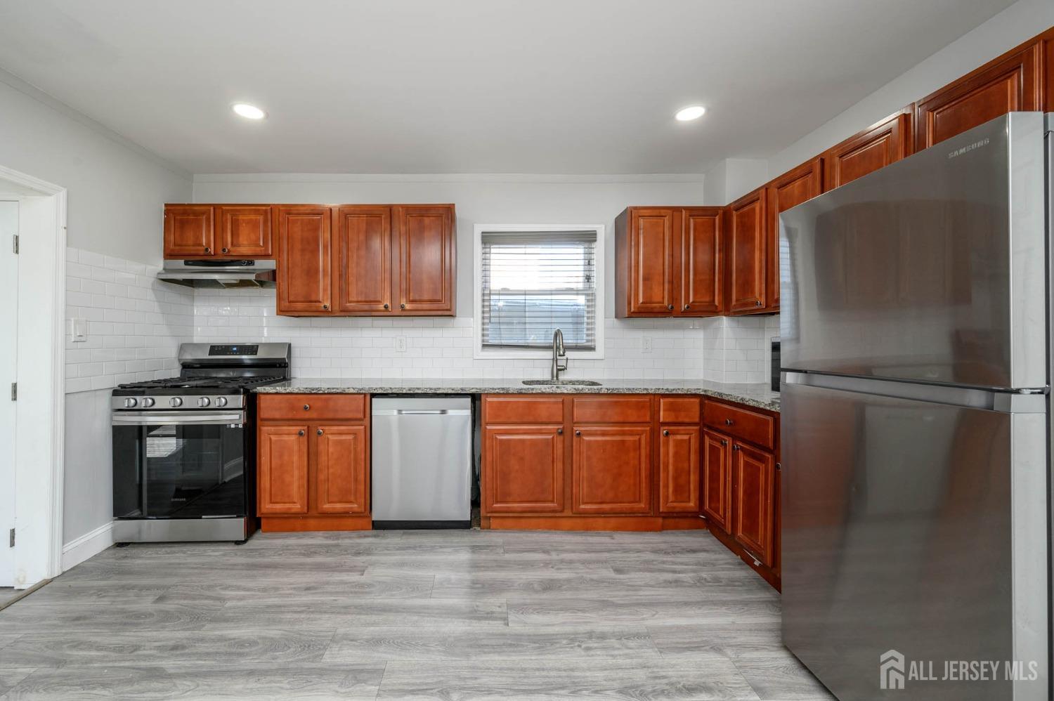 32 Lee Street Port Reading, NJ 07064 - Photo 8 of 32 a kitchen with stainless steel appliances granite countertop a refrigerator sink and stove