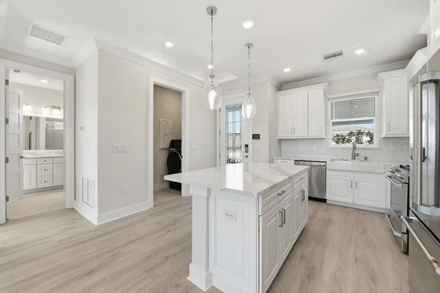 a large white kitchen with a lot of counter space
