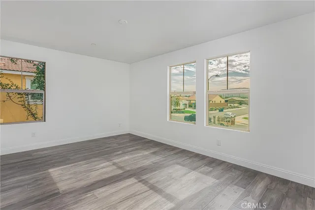 a view of an empty room and wooden floor