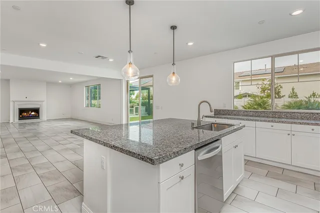 a kitchen with granite countertop a sink and a stove