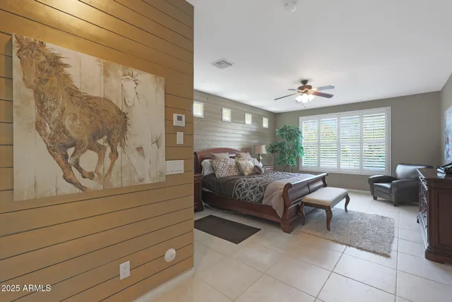 a bedroom with a large bed and a potted plant
