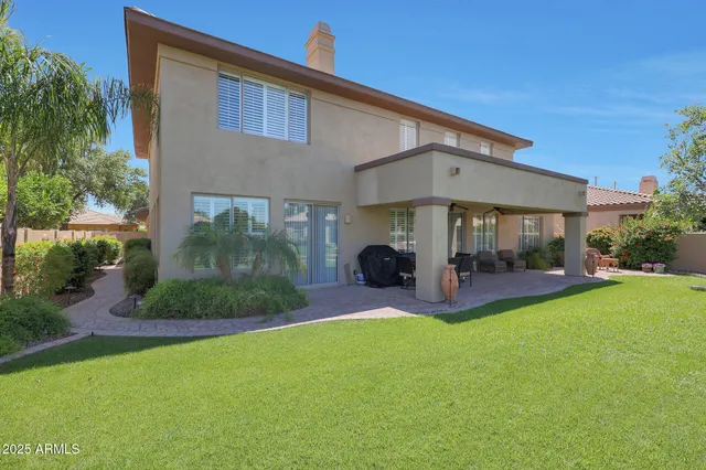 a view of a patio with couches table and chairs and potted plants