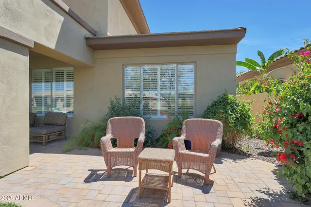 a view of a house with backyard sitting area and garden