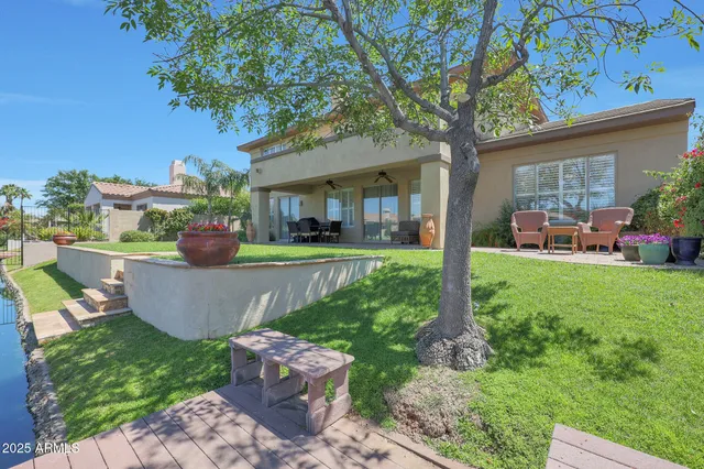 a view of house with garden space and lake view