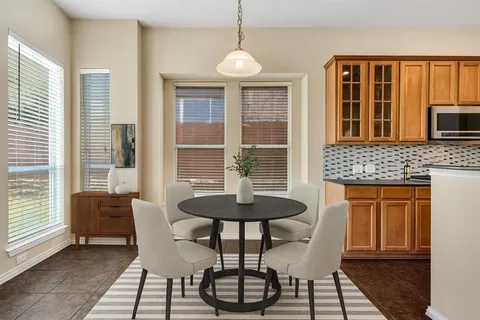 a dining room with furniture and window