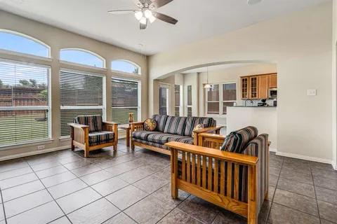 a living room with furniture and two windows