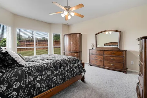 a bedroom with a bed and a dresser