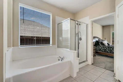 a bathroom with a bathtub and a shower