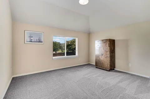 an empty room with windows and closet