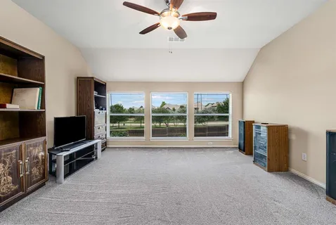 a view of a livingroom with furniture and a flat screen tv