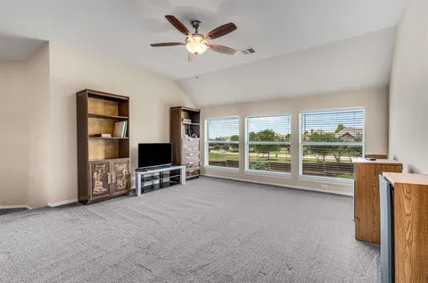 a view of an empty room with a fireplace and a large window