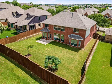 an aerial view of a house with swimming pool garden and patio