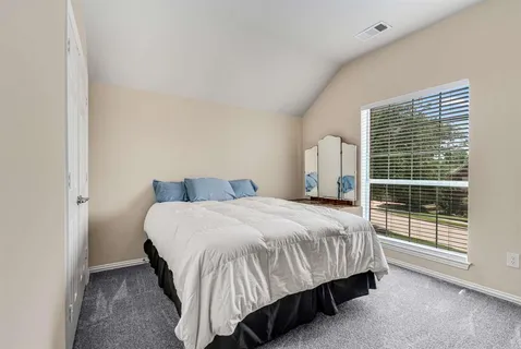 a bedroom with a bed and window