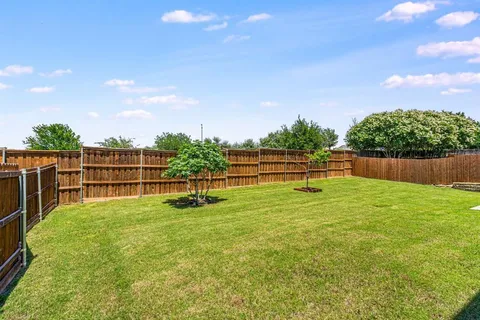 a view of yard with swimming pool and green space