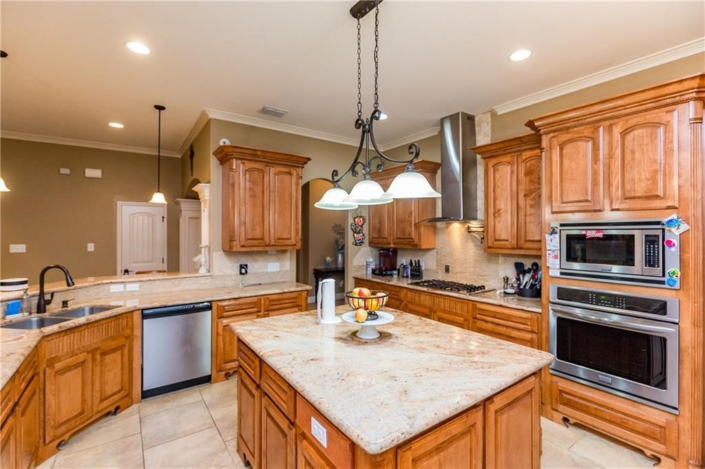 1306 Keenland Road Corpus Christi, TX 78418 - Photo 4 of 26 a kitchen with a stove a sink and a refrigerator