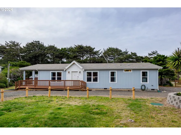 a view of a house with a backyard and a garden