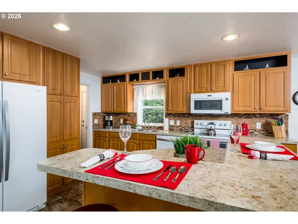 a living room with kitchen island furniture and a kitchen view