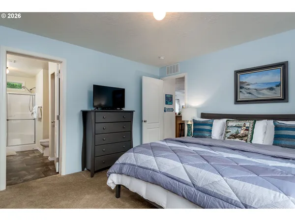 a bedroom with a bed and a television