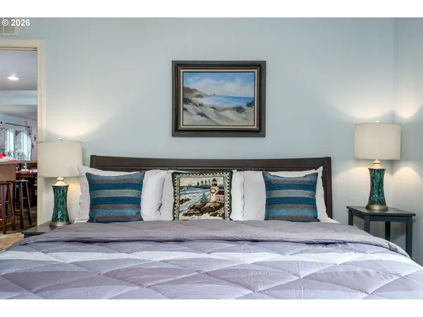 a view of a bedroom with a bed and lamp