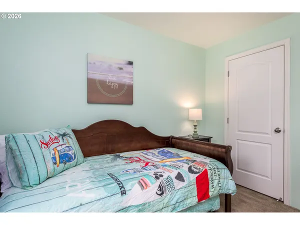 a bedroom with a bed and a painting on the wall