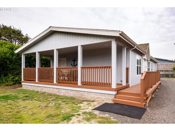 a backyard of a house with deck and furniture