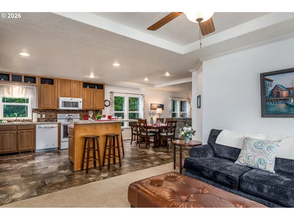 a living room with stainless steel appliances kitchen island granite countertop furniture and a kitchen view