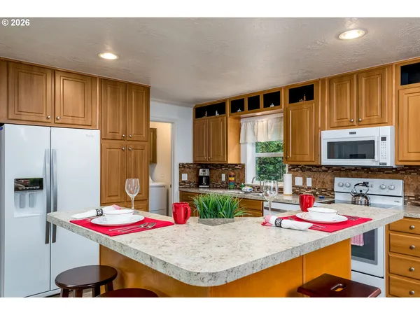 a room with furniture and a open kitchen view