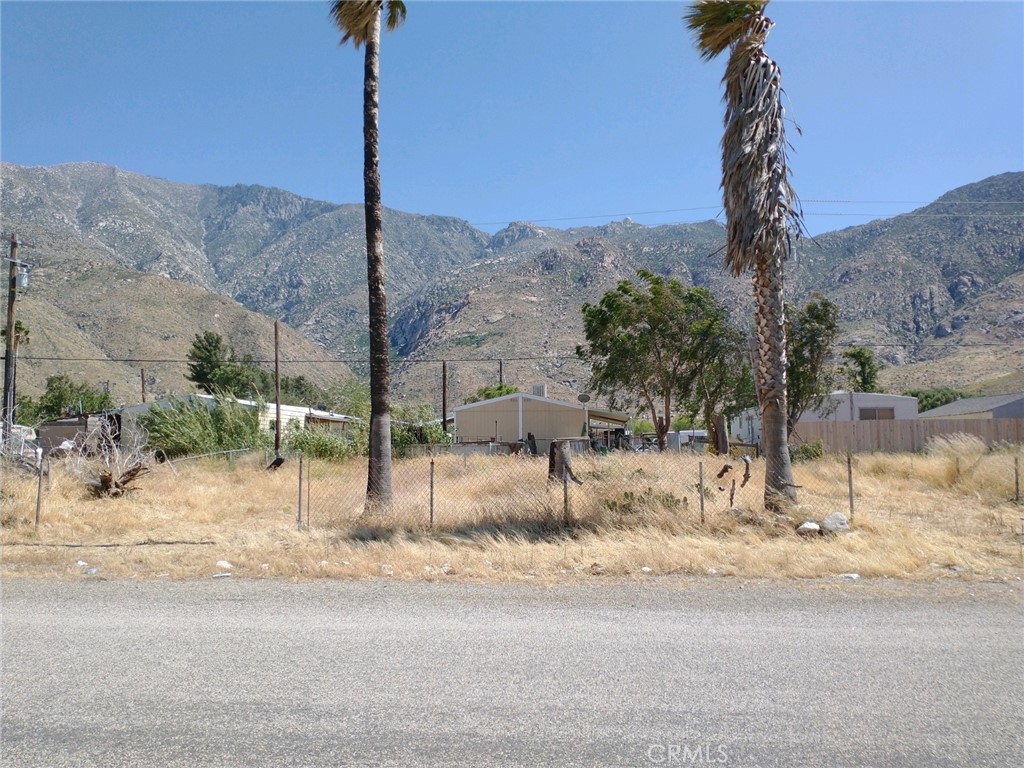 a street sign on a sidewalk next to a road