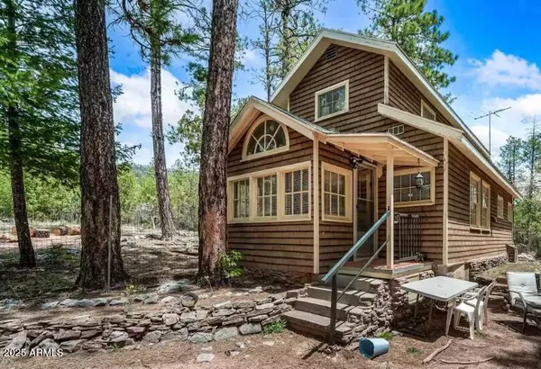 a front view of a house with plants
