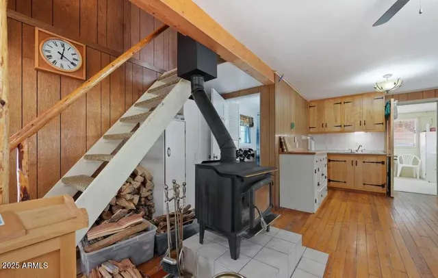 a view of entryway and kitchen with wooden floor
