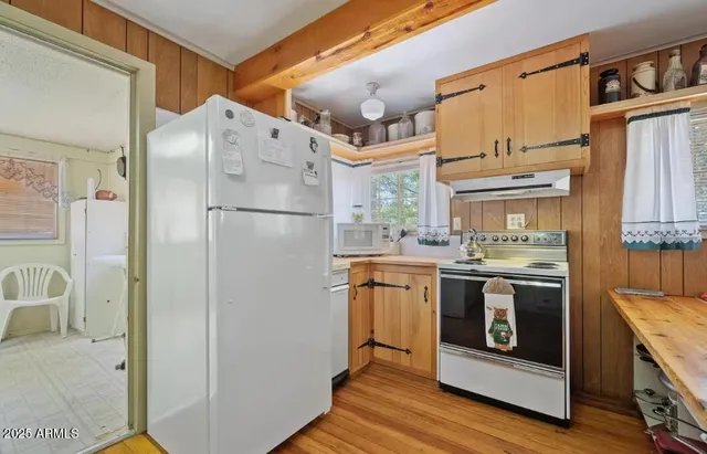a white refrigerator freezer sitting inside of a kitchen