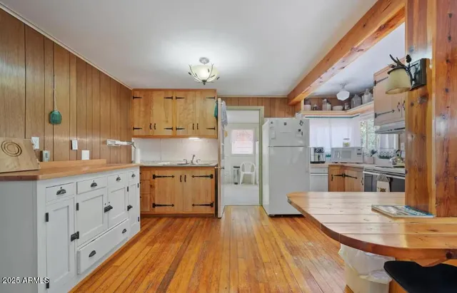 a kitchen with cabinets a sink and wooden floor