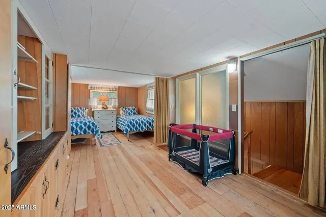 a living room with furniture a flat screen tv and a floor to ceiling window