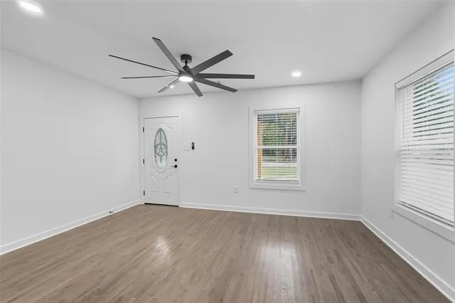 wooden floor in an empty room with a window