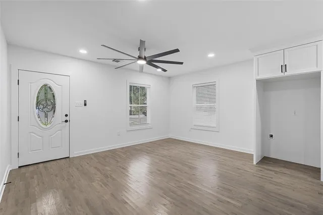a view of room with window and wooden floor