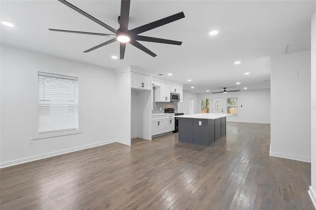 a view of kitchen with stainless steel appliances refrigerator stove microwave and cabinets