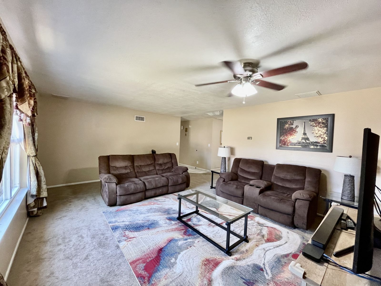 233 West St George Avenue Ridgecrest, CA 93555 - Photo 18 of 47 a living room with furniture and a flat screen tv