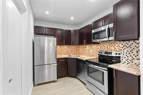 a kitchen with a refrigerator sink and microwave