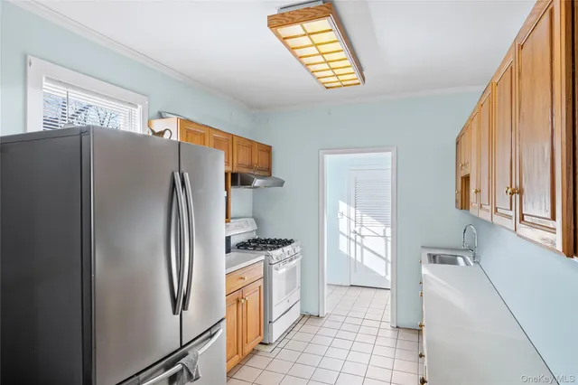 a kitchen with stainless steel appliances a refrigerator sink and cabinets