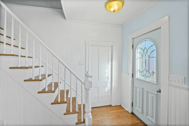 a view of staircase with wooden floor and a chandelier
