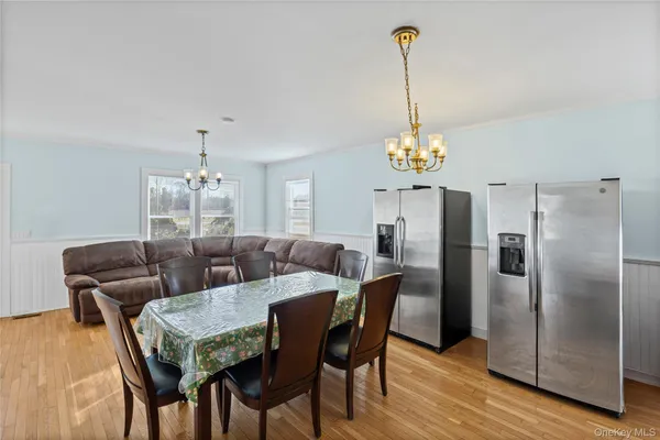 a view of a dining room with furniture wooden floor and chandelier
