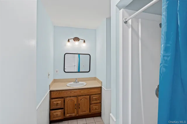 a bathroom with a sink mirror and vanity